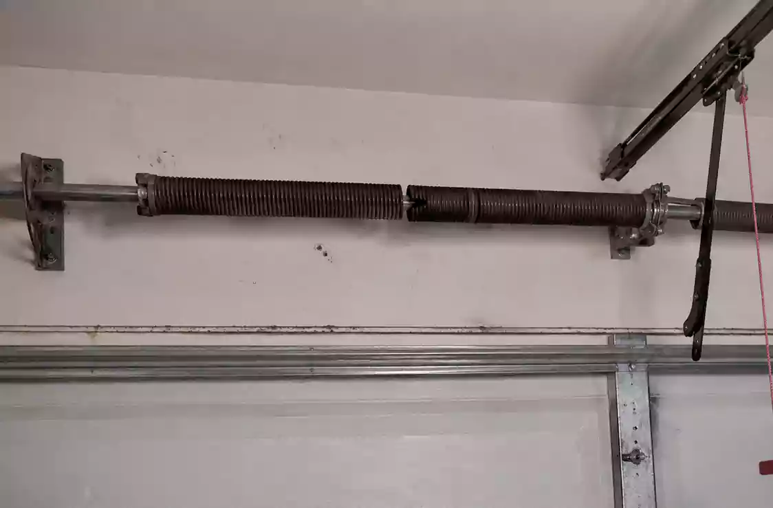 Garage Door Spring Repair CA checking uneven travel and unusual spring sounds